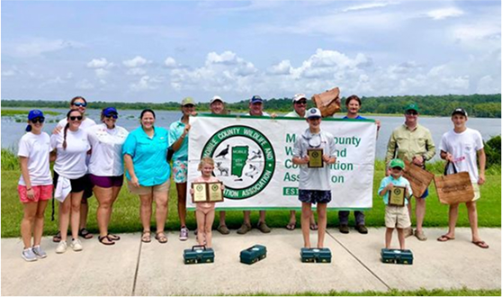 people with awards and banner