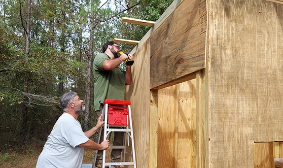 men building shooting house